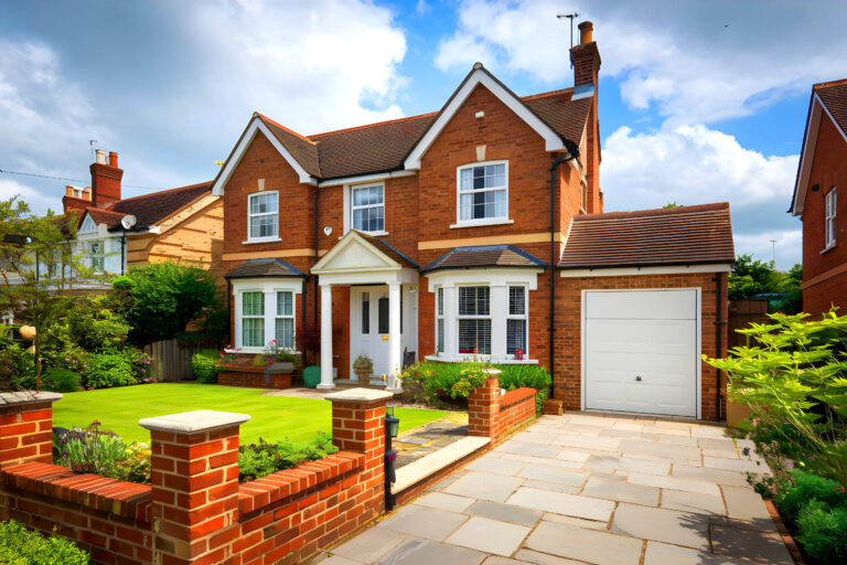 Red-brick detached family house with garage, front garden and paved driveway in Pontefract, representing rental property investment opportunities.