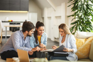 Couple discussing property deal with agent about gazumping risk