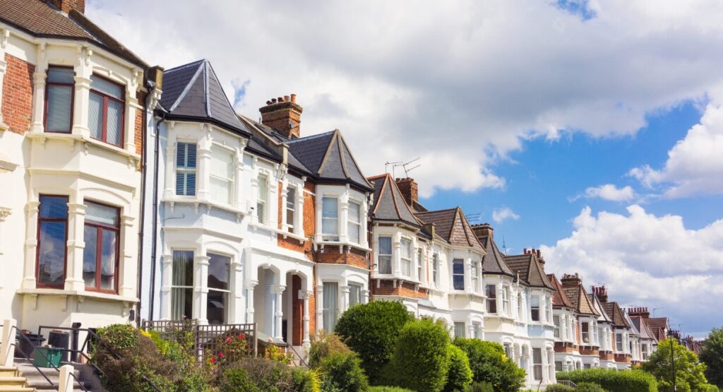 A row of traditional UK terraced houses under a bright sky, representing Whitegates’ guide on which home renovations offer the best return on investment in 2025.