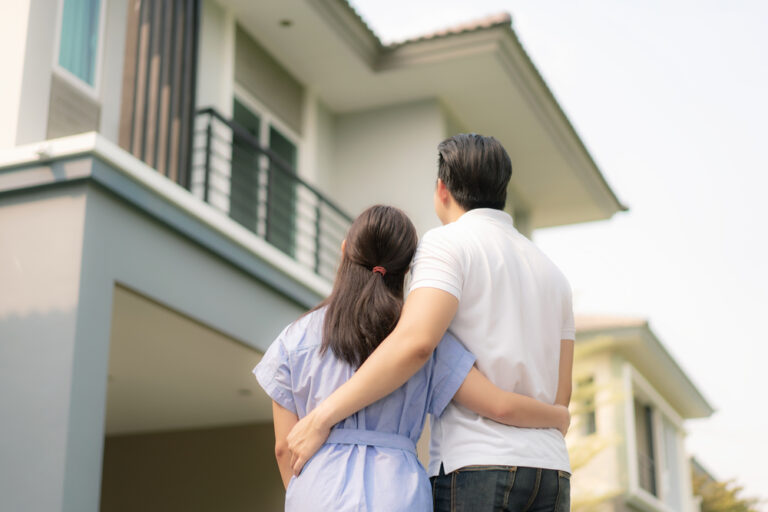 Couple admiring their new modern house together