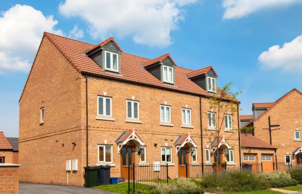Row of brick houses under a blue sky