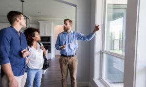 Letting agent inspecting a rental property with a couple in West Derby, discussing Decent Homes Standard requirements for private landlords in 2026