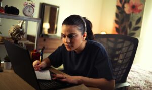 Landlord reviewing rental income notes while updating digital tax records for Making Tax Digital compliance