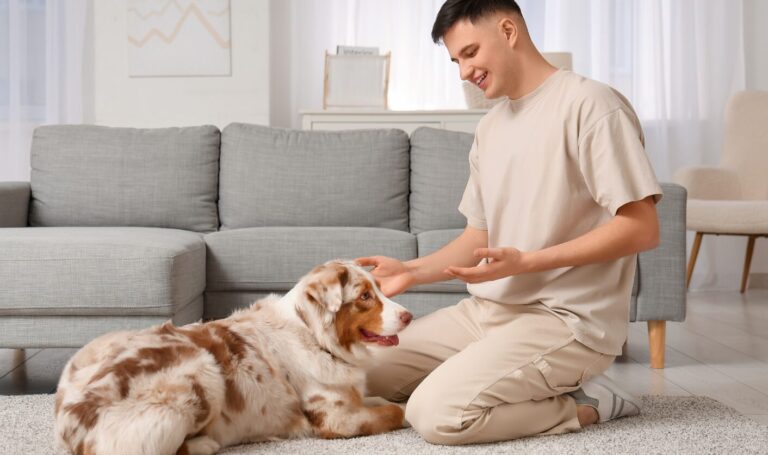Tenant sitting on the floor of a modern rental living room with his dog, reflecting new 2026 rules allowing tenants to request permission to keep pets