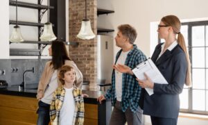 Letting agent speaking with a family inside a rental home, representing Decent Homes Standard compliance for private landlords from 2026