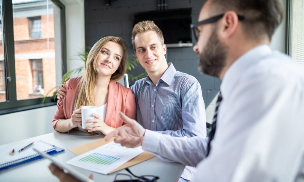 Landlord couple discussing rental documents with letting agent, representing landlord legal help in the UK