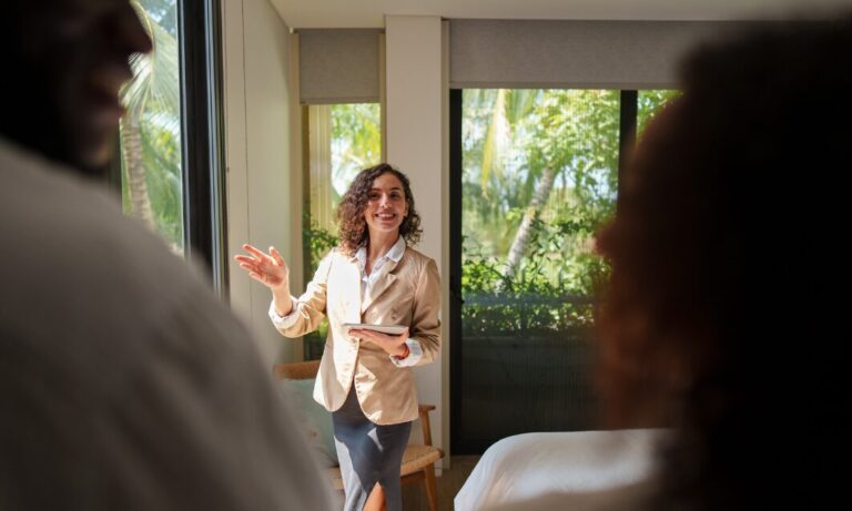 Estate agent discussing property details with couple, representing landlord legal help and compliance in the UK rental market