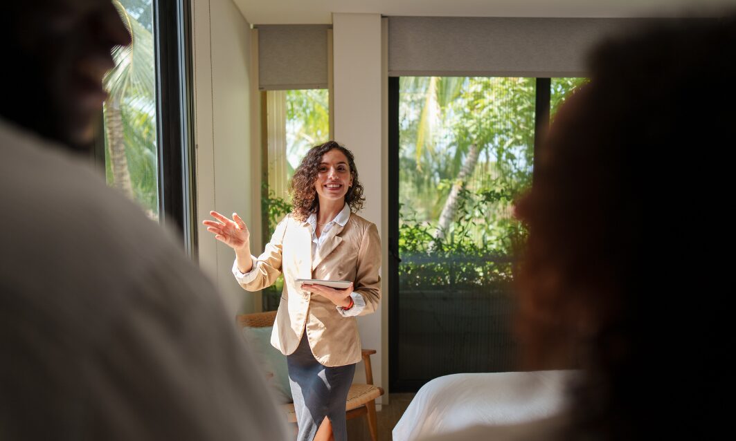 Estate agent discussing property details with couple, representing landlord legal help and compliance in the UK rental market