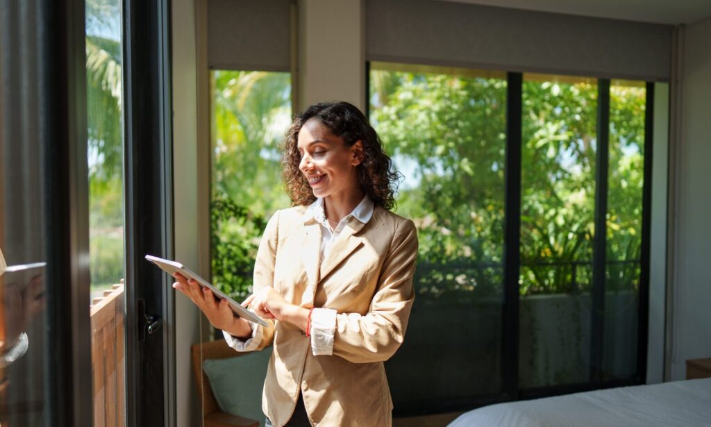 A property manager using a tablet while inspecting a modern rental property in Huyton.