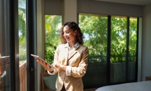 A property manager using a tablet while inspecting a modern rental property in Huyton.