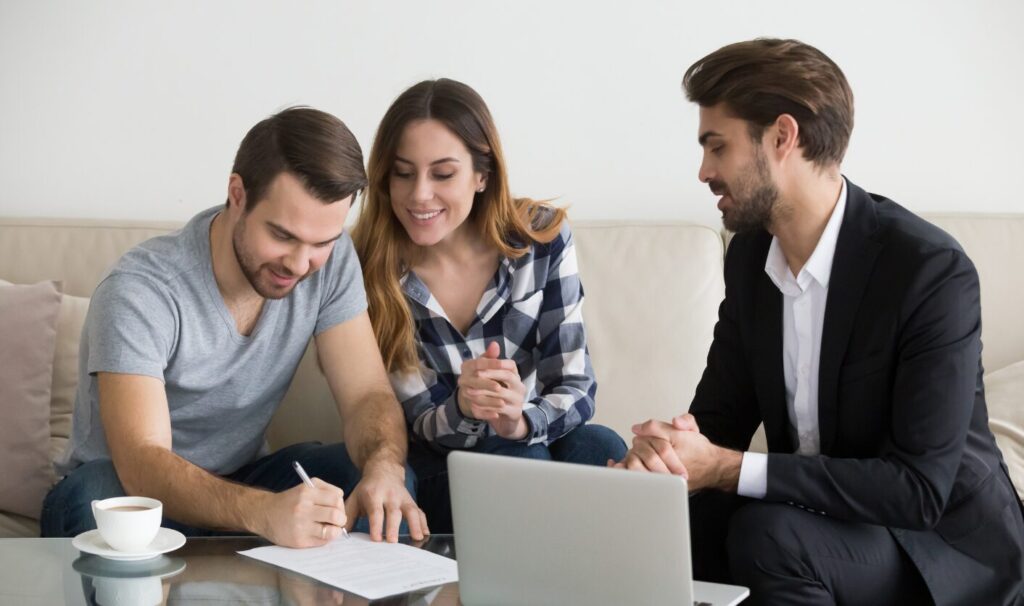 A landlord reviewing documents with a prospective tenant at a table.