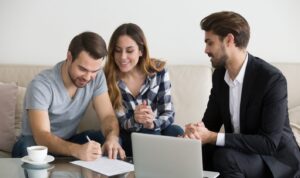 A landlord reviewing documents with a prospective tenant at a table.