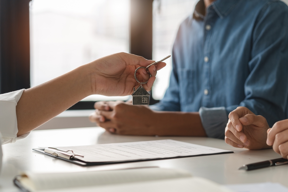 Handing over house keys above property agreement document