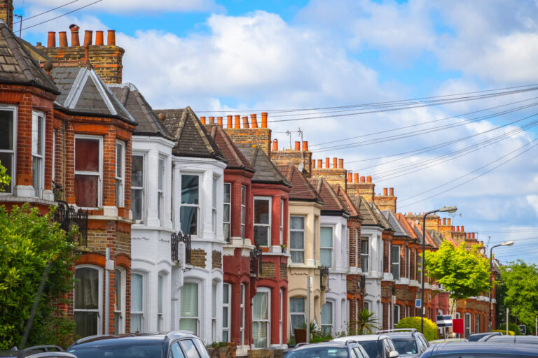 Row of red-brick terraced houses on a residential street in Bootle
