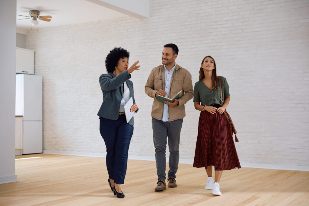 estate agent showing a property to a couple during a home viewing in Walton Liverpool