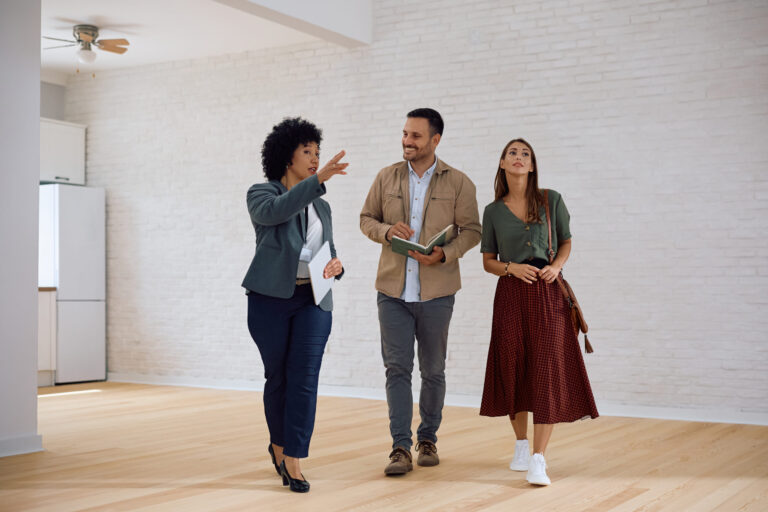estate agent showing a property to a couple during a home viewing in Walton Liverpool