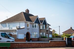 Detached suburban house with driveway and front garden