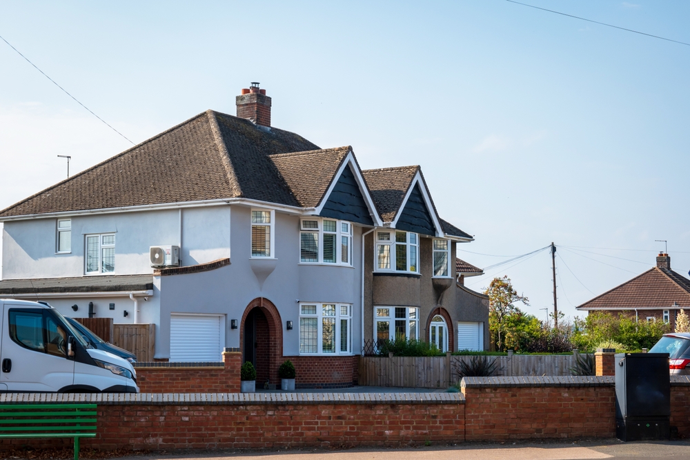 Detached suburban house with driveway and front garden