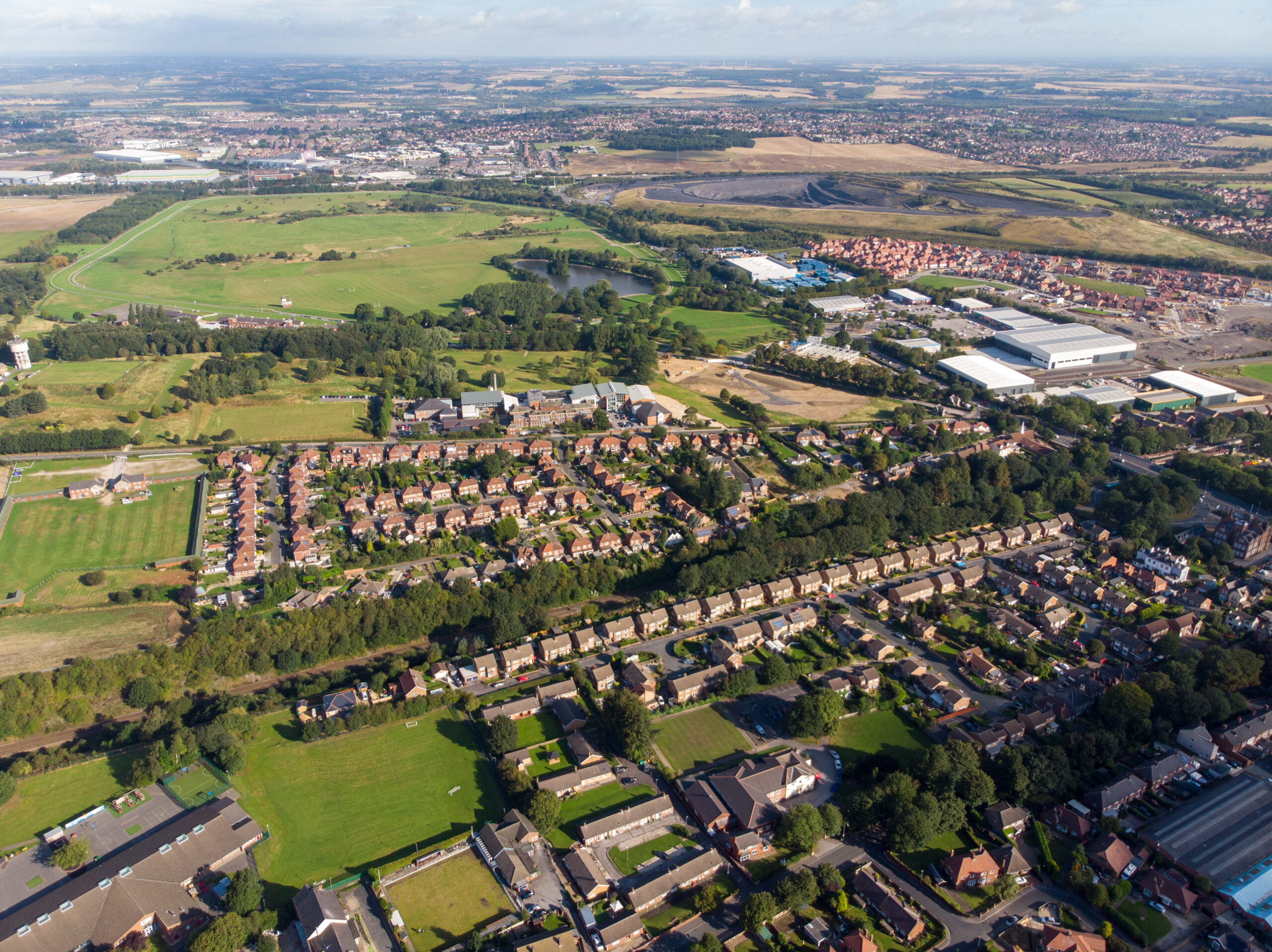 Drone view of Pontefract neighbourhoods, green spaces and residential housing in West Yorkshire
