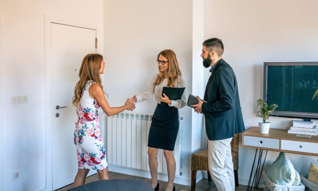 Letting agent welcoming landlord clients during a property management meeting in Woolton