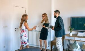 Letting agent welcoming landlord clients during a property management meeting in Woolton