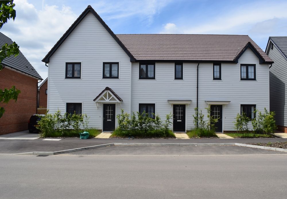 Modern white terraced houses in a newly built UK neighbourhood