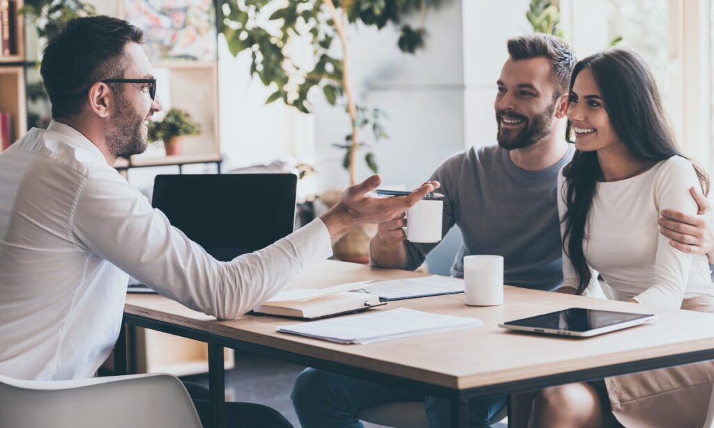 Letting agent discussing property details with tenants, representing Pontefract landlord advice, tenant profiling and rental property management.