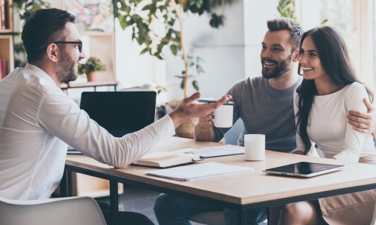 Letting agent discussing property details with tenants, representing Pontefract landlord advice, tenant profiling and rental property management.