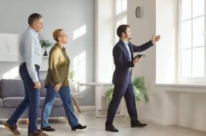 Couple viewing a potential second home with an estate agent