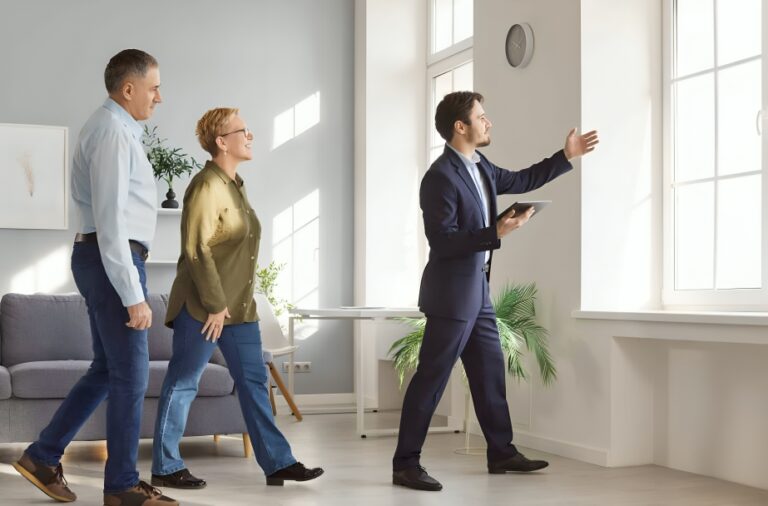 Couple viewing a potential second home with an estate agent