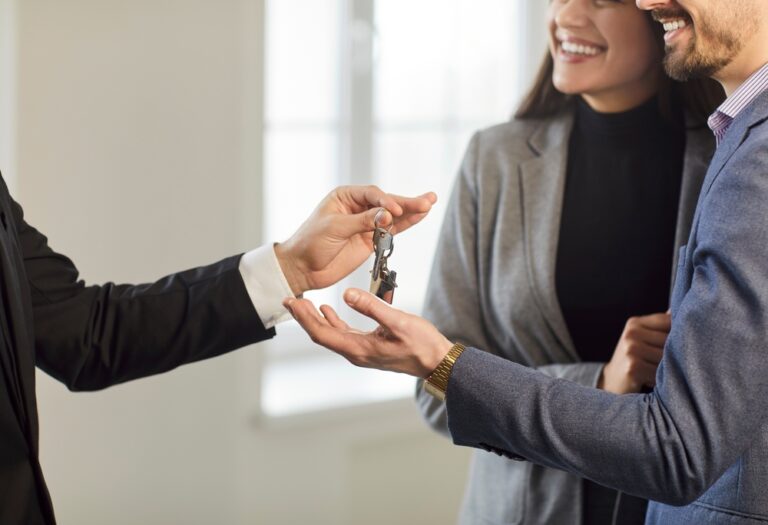 Guarantor handing over house keys during rental agreement process