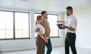 Estate agent showing a modern property to a couple during a house viewing in Castleford WF10.