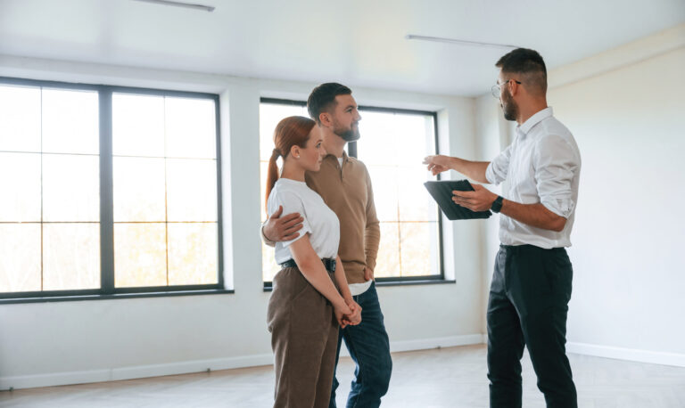 Estate agent showing a modern property to a couple during a house viewing in Castleford WF10.
