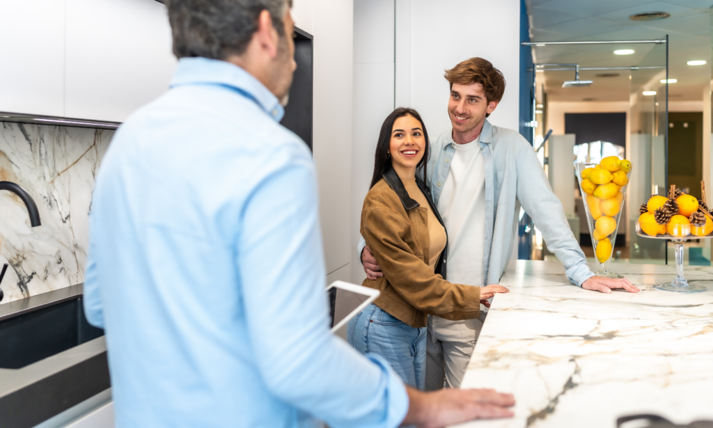 Couple speaking with an estate agent while viewing a modern home in West Derby.