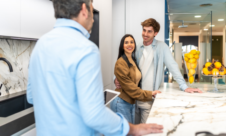 Couple speaking with an estate agent while viewing a modern home in West Derby.