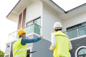 Building surveyors inspecting a modern residential property exterior