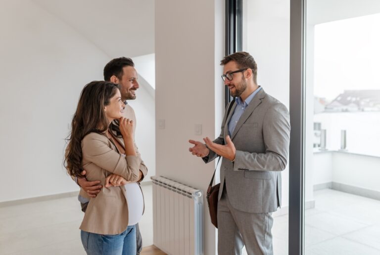 Estate agent discussing property features with a couple during a house viewing