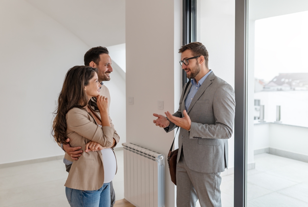 Estate agent discussing property features with a couple during a house viewing