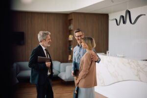 Property adviser discussing home values with a couple in Huyton, L36