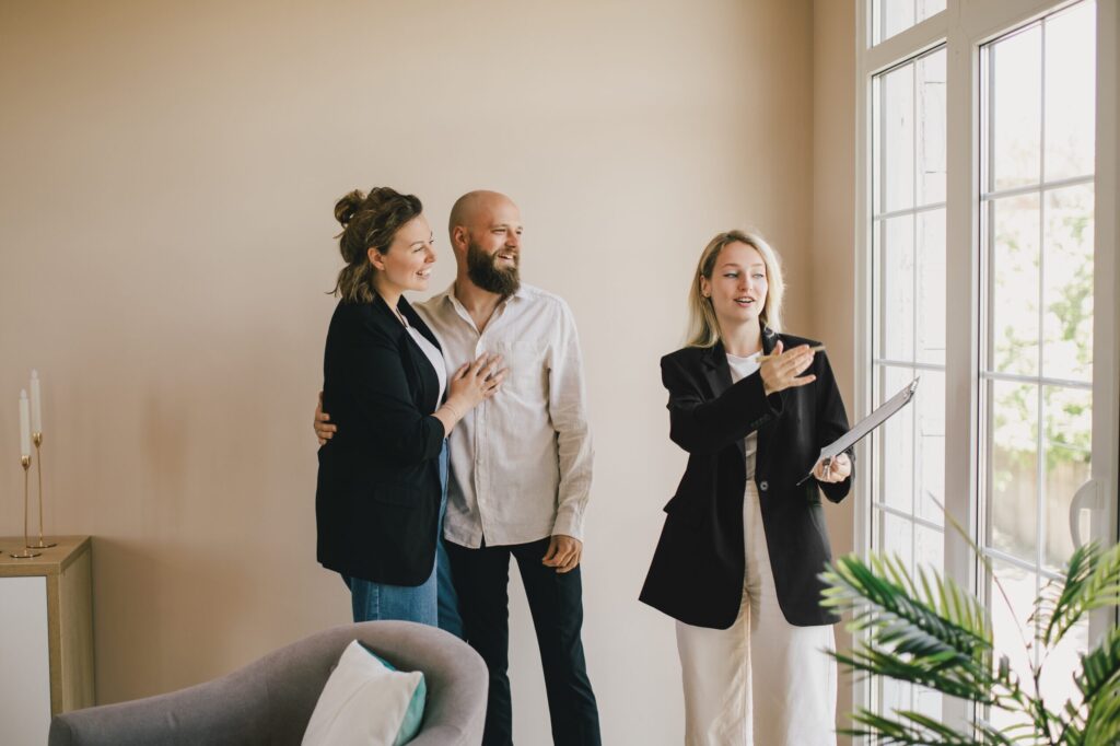 Landlord couple viewing a rental property with a letting agent during a property appraisal