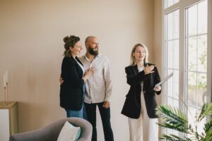 Landlord couple viewing a rental property with a letting agent during a property appraisal